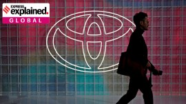 FILE PHOTO: A man walks past a Toyota logo at the Tokyo Motor Show, in Tokyo, Japan October 24, 2019.