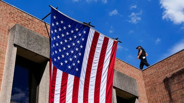 A member of the U.S. Secret Service walks on the roof as U.S. President Joe Biden (not pictured) attends a campaign event in Harrisburg, Pennsylvania, U.S., July 7, 2024. 