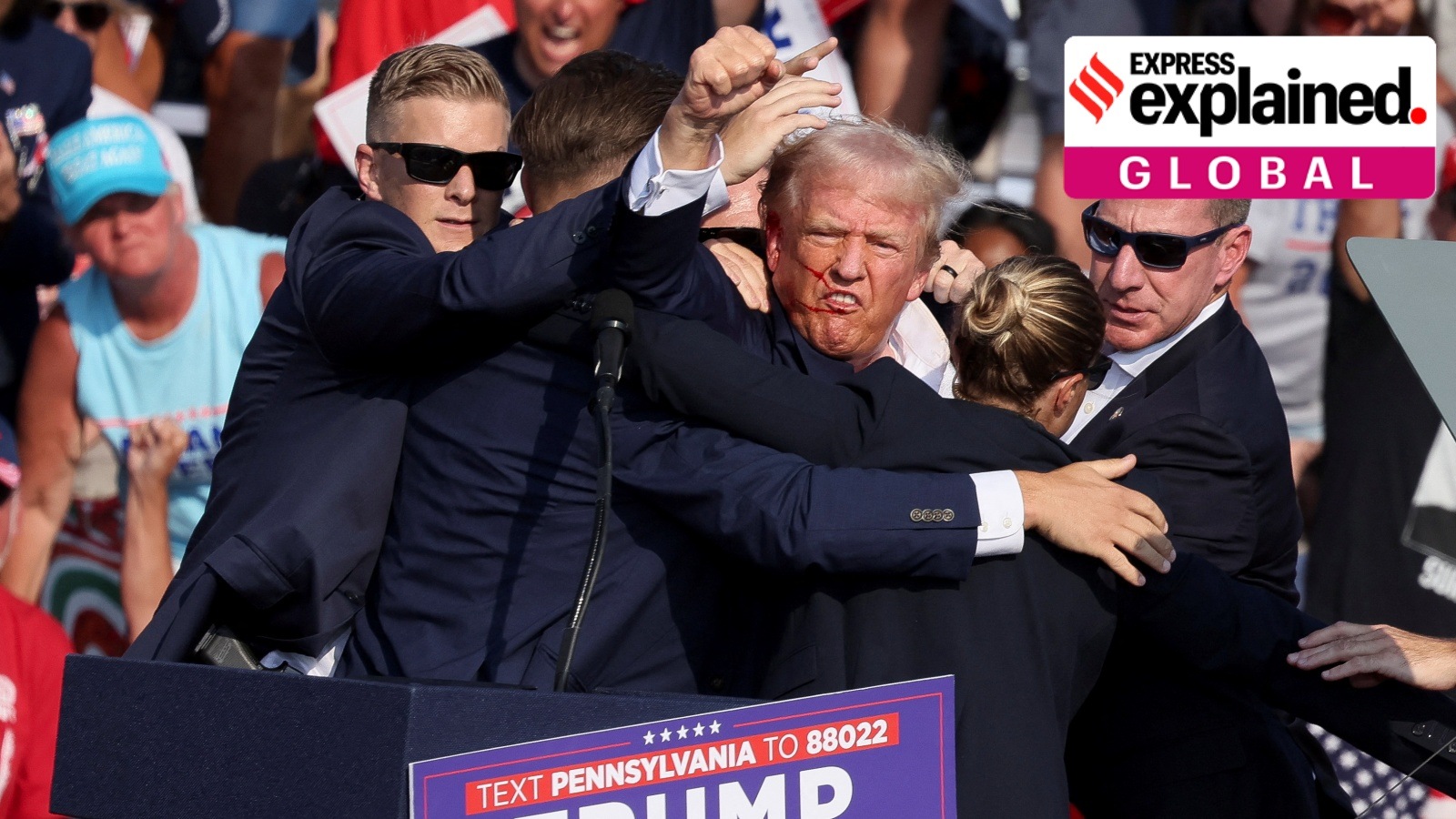 Republican presidential candidate and former U.S. President Donald Trump gestures with a bloodied face while he is assisted by U.S. Secret Service personnel after he was shot in the right ear during a campaign rally at the Butler Farm Show in Butler, Pennsylvania, U.S., July 13, 2024.