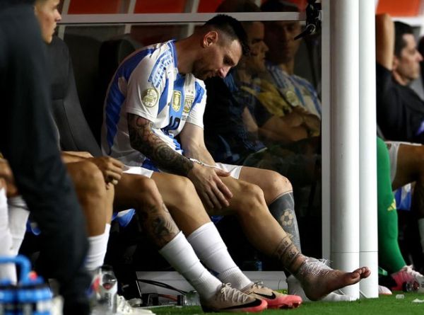 Messi's right ankle was taped up with an ice pack after being forced off the field. (Reuters)