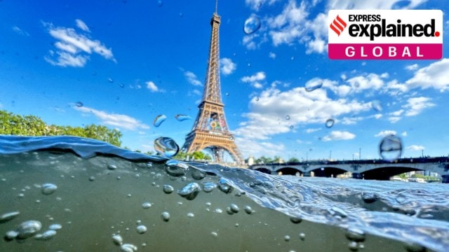 The Eiffel Tower is seen from the water of the Seine River as the Olympics opening ceremony rehearsal is postponed amid rainy weather.