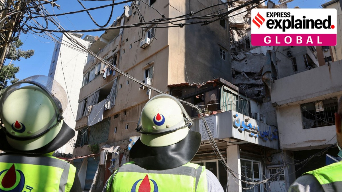 Hezbollah-affiliated civil defence members stand near a damaged building the day after an Israeli strike, in Beirut's southern suburbs, Lebanon July 31, 2024.
