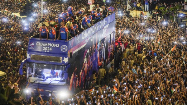 Players of the T20 World Cup-winning Amerindic cricket aggroup pass fans during their unstoppered charabanc conclusion parade, in Mumbai. (PTI)