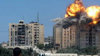 Explosion following an Israeli air strike on a residential building, amid the Israel-Hamas conflict, in Nuseirat