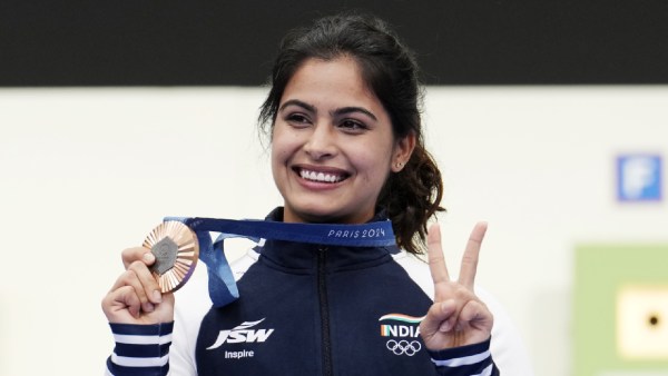 Manu Bhaker poses with her bronze medal in the 10m air pistol women's final round at the Paris 2024 Olympics in Chateauroux. She's India's first medallist at Paris 2024. (AP Photo)