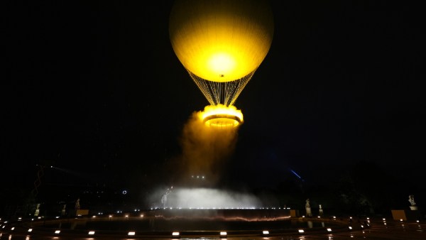 Teddy Riner and Marie-Jose Perec watch as the cauldron rises in a balloon in Paris, France, during the opening ceremony of the 2024 Summer Olympics, Friday, July 26, 2024. (AP Photo)