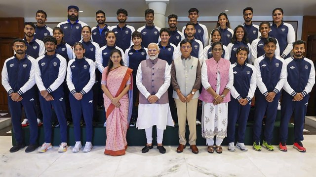 Prime Minister Narendra Modi with Union Minister of Youth Affairs and Sports Mansukh Mandaviya and Indian Olympic Association President PT Usha poses for a group photo with the Indian contingent heading for the upcoming Paris Olympics