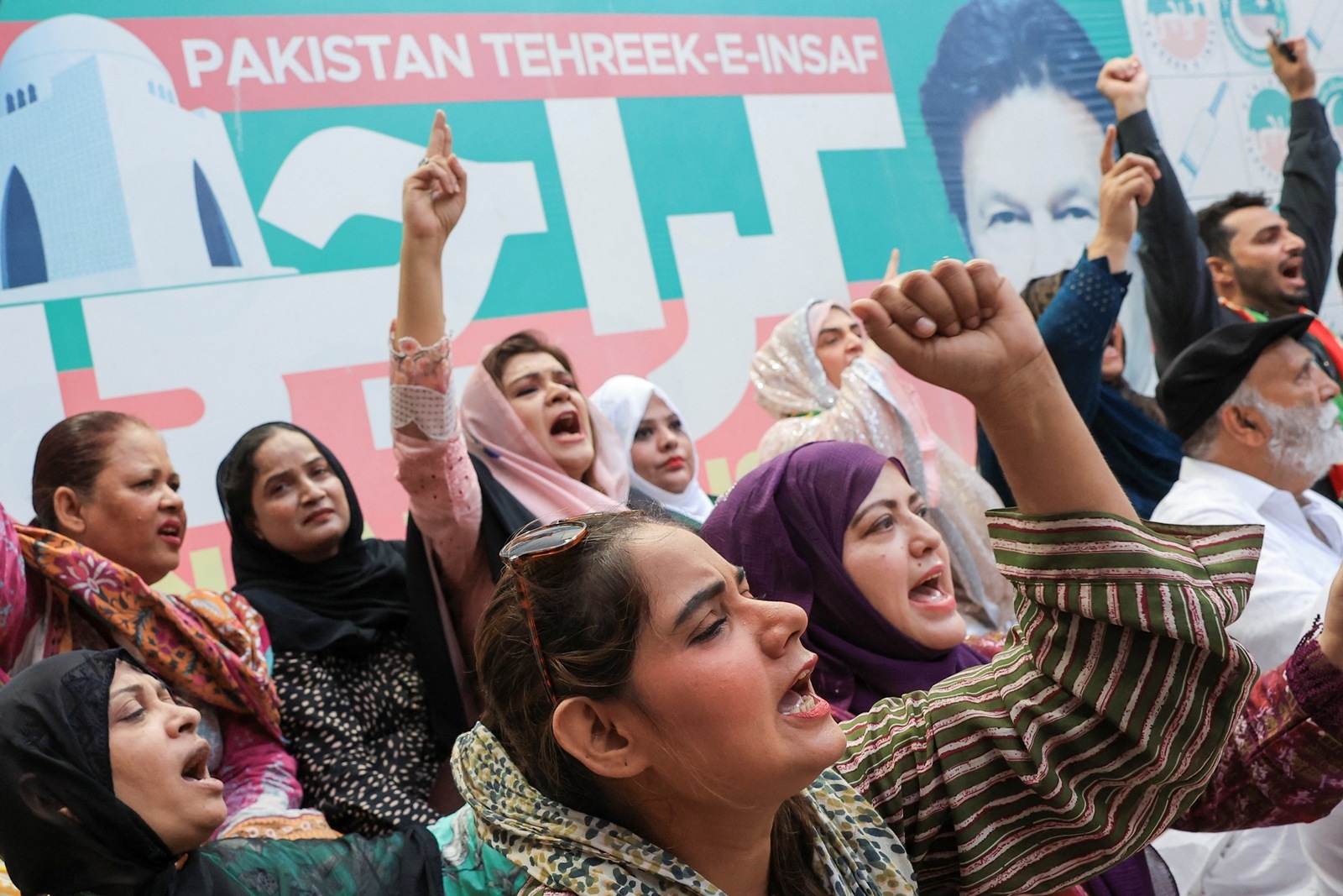 Supporters of the political party Pakistan Tehreek-e-Insaf (PTI), chant slogans as they celebrate after Pakistan's Supreme Court ruled that jailed former Prime Minister Imran Khan's party was eligible for over 20 extra reserved seats in parliament. (Reuters)