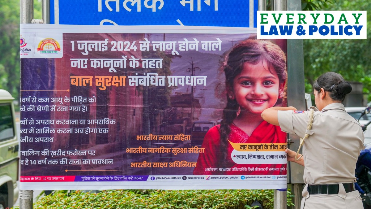 A poster depicting the implementation of three new criminal laws being put up by Delhi Police to raise awareness, in New Delhi, Monday, July 1, 2024.