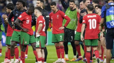 Portugal's Cristiano Ronaldo, center, reacts after losing a quarter final match between Portugal and France at the Euro 2024 soccer tournament in Hamburg, Germany, Friday, July 5, 2024. France won a penalty shoot out 4-3 after the match ended in a 0-0 draw. (AP Photo)