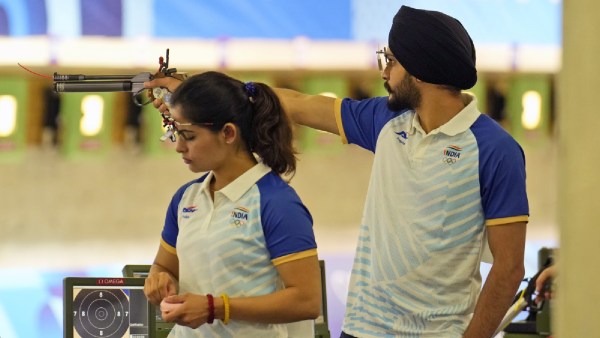 India's Manu Bhaker, left, and teammate Sarabjot Singh compete in the 10m air pistol mixed team qualification round at the 2024 Summer Olympics