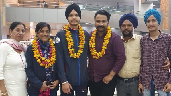 A young Sarabjot with coach Abhishek Rana and father