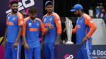 (R-L), India's captain Rohit Sharma and teammates Suryakumar Yadav, Kuldeep Yadav and Mohd Siraj stand next to the winners' trophy after winning against South Africa in the ICC Men's T20 World Cup final cricket match at Kensington Oval in Bridgetown, Barbados, Saturday