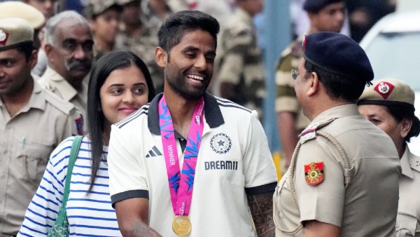A police personnel greets Indian cricketer Suryakumar Yadav at New Delhi airport, Thursday, July 4, 2024. Indian cricket team on Thursday returned home after winning the ICC Men's T20 World Cup 2024 in Barbados.