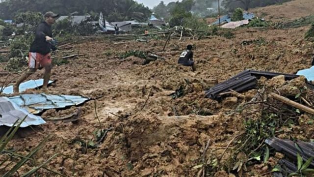 Rescuers search for dozens buried in an Indonesian landslide that