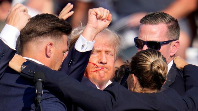 Republican presidential candidate and former President Donald Trump is helped off the stage by US Secret Service agents after an attempt was made at his life at a campaign rally. (AP)