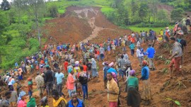 Most of the victims were buried in a mudslide on Monday morning as rescue workers searched the steep terrain for survivors of another mudslide the previous day. (AP Photo)