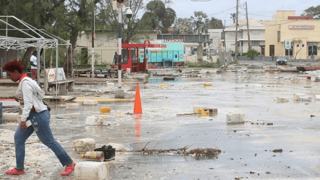 A woman walks through a debris filled street in the Hastings neighborhood after Hurricane Beryl passed in Bridgetown, Barbados. (Reuters)