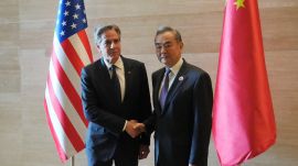 US Secretary of State Antony Blinken, left, shakes hands with Chinese counterpart Wang Yi (AP)