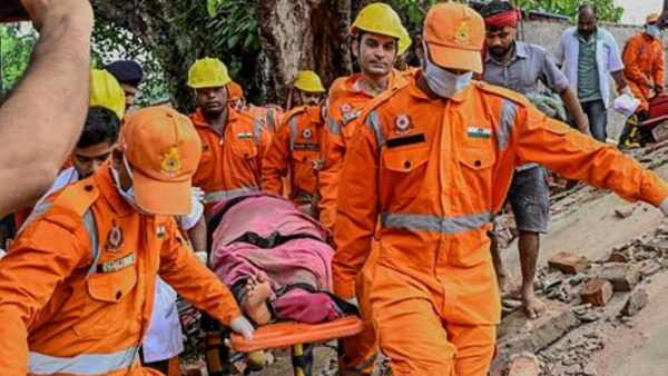 NDRF personnel during a rescue operation after a multi-storey building collapsed, in Deoghar district. (PTI photo)