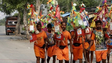 Kanwar Yatris marching on in New Delhi on Friday. (Express Photo by Amit Mehra). Kanwar Yatra