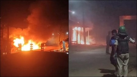 Security personnel stand guard after shops and houses were set on fire following the death of a youth, in Gandacherra subdivision of Dhalai district. (Photos: PTI)