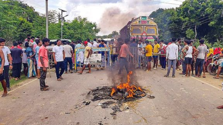 Smoke and flames billow out after a tyre was set on fire during a protest by locals against long hours of frequent power cuts, at Manikchak area in Malda district, Thursday, July 18, 2024. (PTI Photo)