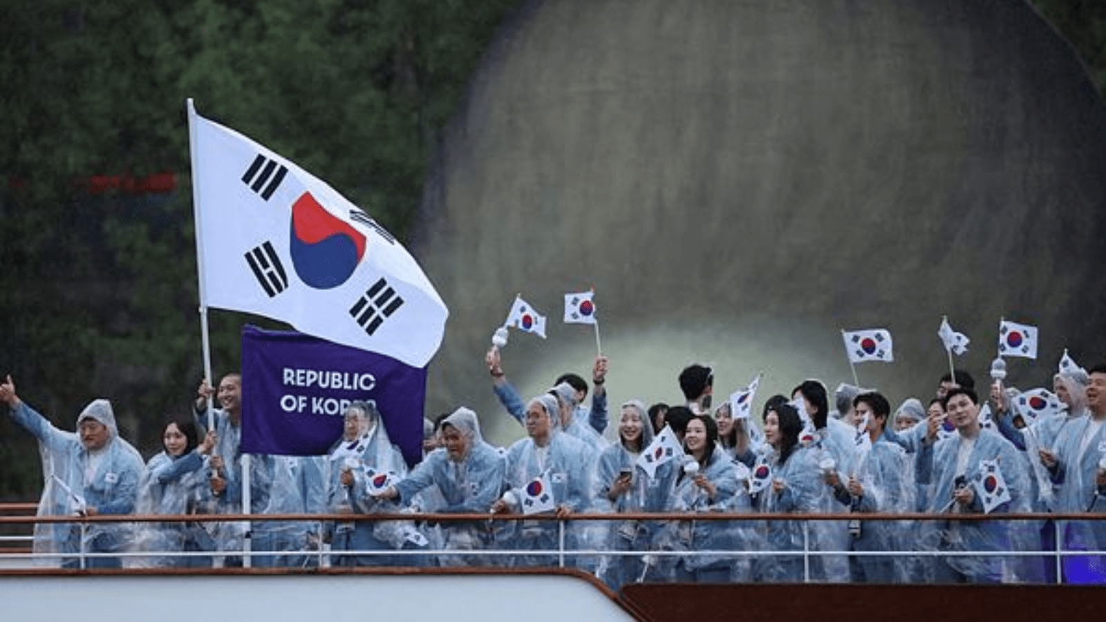 Athletes of South Korea aboard a boat in the floating parade on the river Seine during the opening ceremony. (REUTERS)