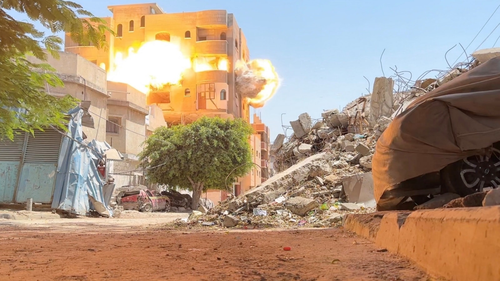 Smoke and flames rise from a house hit by an Israeli strike, amid the ongoing conflict between Israel and Hamas, in Nuseirat refugee camp, in the central Gaza Strip, in this still picture taken from a video