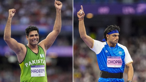 Pakistan's Arshad Nadeem and India's Neeraj Chopra celebrate after their respective second attempts during the men's javelin throw final at the 2024 Summer Olympics, in Paris, France