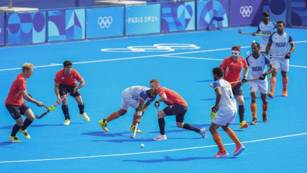 India's Manpreet Singh (7) vies for the ball with Great Britain's Jack Waller (3) during the Hockey Men’s Quarterfinal match between India and Great Britain at the 2024 Summer Olympics, at Yves-du-Manoir Stadium, in Colombes, France
