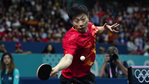 China's Ma Long, with his teammate Wang Chuqin, plays against Sweden's Anton Kallberg and Kristian Karlsson during the men's gold medal team table tennis match at the 2024 Paris Olympics (AP)