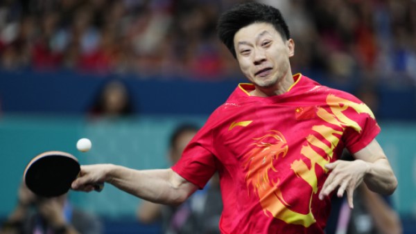 China's Ma Long, with his teammate Wang Chuqin, plays against Sweden's Anton Kallberg and Kristian Karlsson during the men's gold medal team table tennis match at the 2024 Paris Olympics. (AP)