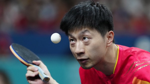 China's Ma Long, with his teammate Wang Chuqin, plays against Sweden's Anton Kallberg and Kristian Karlsson during the men's gold medal team table tennis match at the 2024 Paris Olympics (AP)