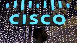 A man passes under a Cisco logo at the Mobile World Congress in Barcelona, Spain February 25, 2019.