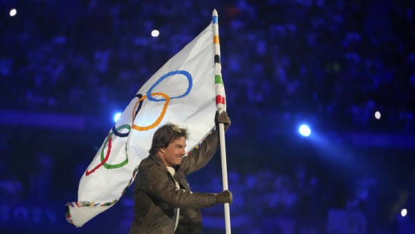 Tom Cruise carries the Olympic flag during the 2024 Summer Olympics closing ceremony at the Stade de France, Sunday. (AP)