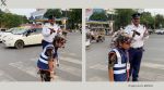 The viral video shows Aditya Tiwari distributing candies to those wearing helmets (Image source: @ANI/X)