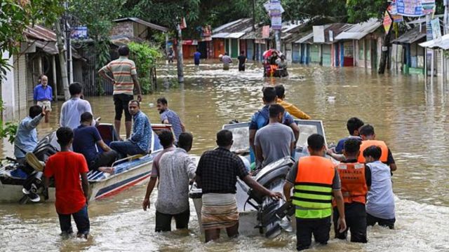 Volunteers take a motor boat to rescue people stranded in flooded residential areas in Feni, a coastal district in southeast Bangladesh