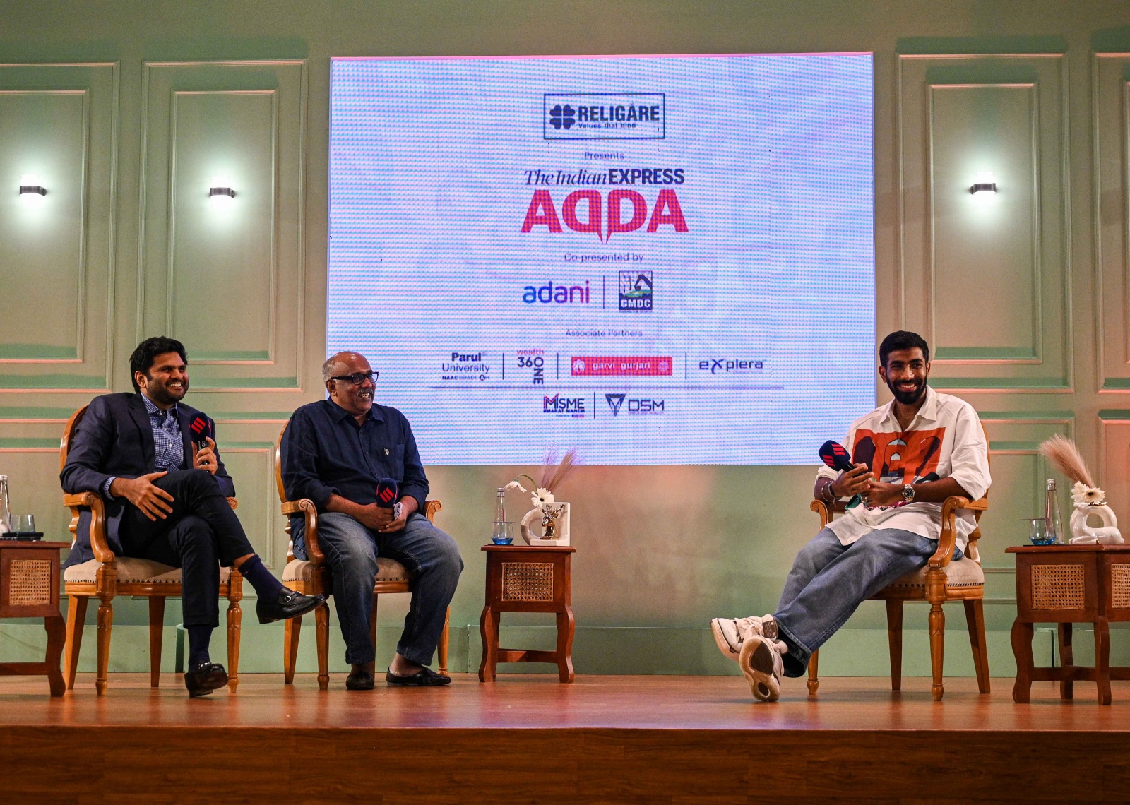 Cricketer Jasprit Bumrah, Executive director of The Indian Express group Anant Goenka and Sandeep Dwivedi interact during an Indian Express Adda event in Ahmedabad on 25 July 2024. (Express Photo by Sankhadeep Banerjee)