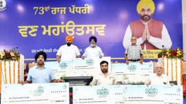 Farmers with the cheque they received as carbon credit compensation, during an event in Hoshiarpur, Tuesday. (Express Photo)