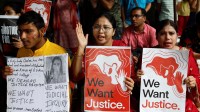 Doctors hold signs as they attend a protest condemning the rape and murder of a trainee doctor, inside the premises of R. G. Kar Medical College and Hospital in Kolkata