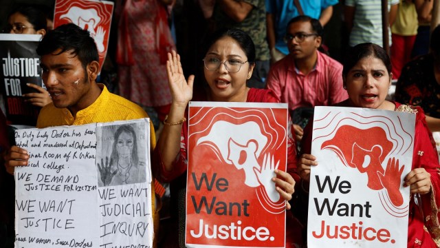 Doctors hold signs as they attend a protest condemning the rape and murder of a trainee doctor, inside the premises of R. G. Kar Medical College and Hospital in Kolkata