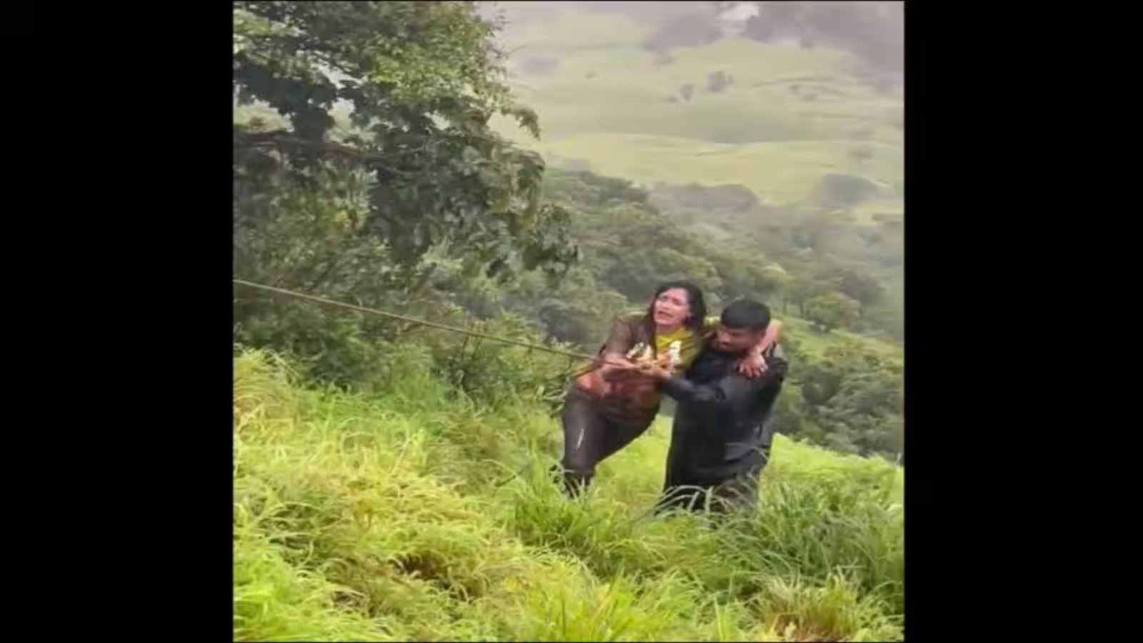 The woman being pulled back from the gorge with the help of a rope. (File Photo)