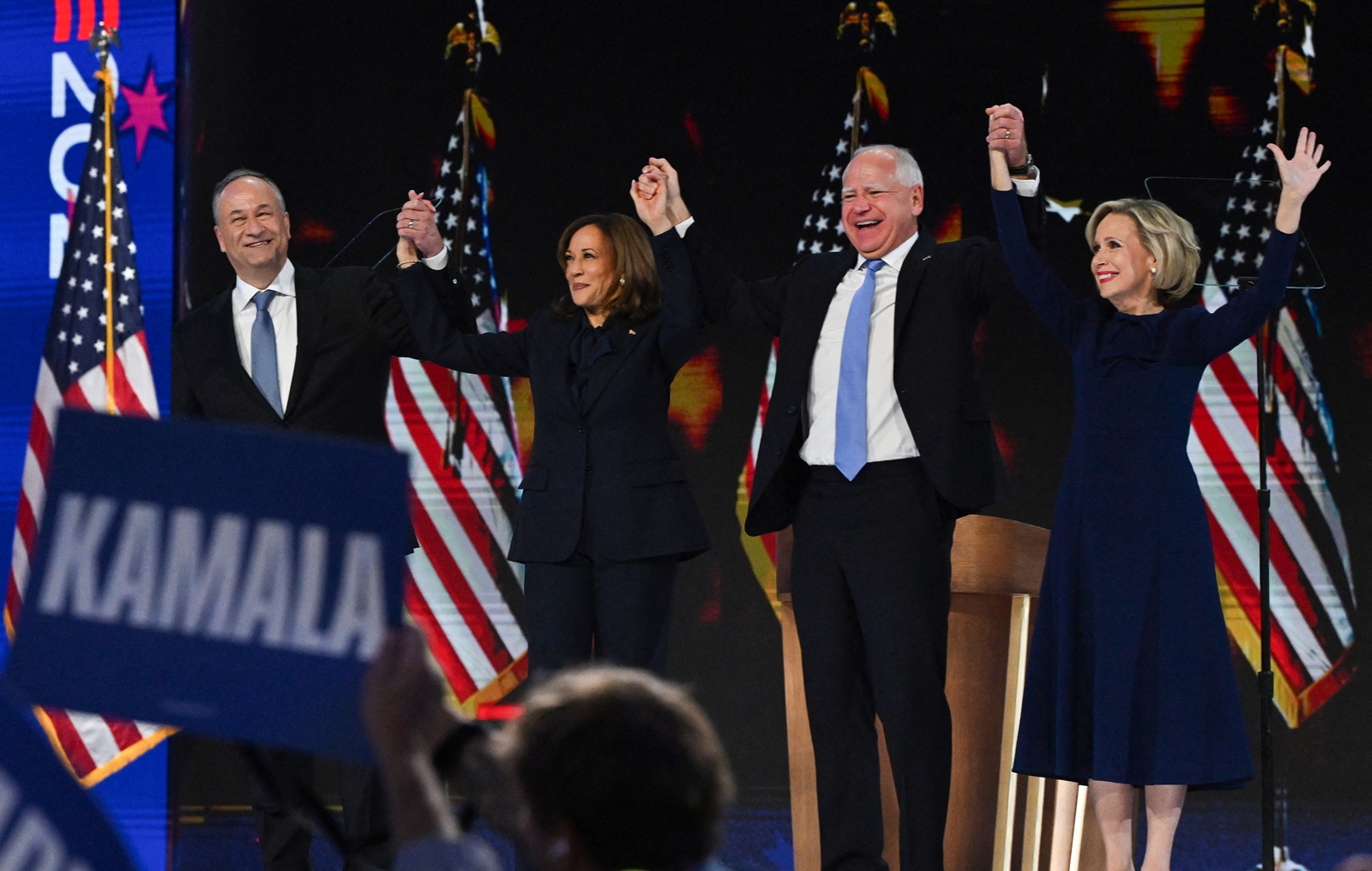 Democratic presidential nominee and US Vice President Kamala Harris, her husband Doug Emhoff, Democratic vice presidential nominee and Minnesota Governor Tim Walz, and his wife Gwen stand onstage on Day 4 of the Democratic National Convention. (Reuters)