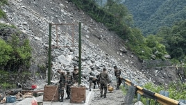 Army personnel reconstruct a bridge that got damaged by a landslide, at Sonprayag in Rudraprayag district. (PTI Photo)