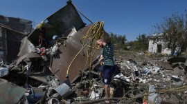 A local resident sorts items next to his house damaged during a Russian missile and drone strike, amid Russia's attack on Ukraine. (Reuters)