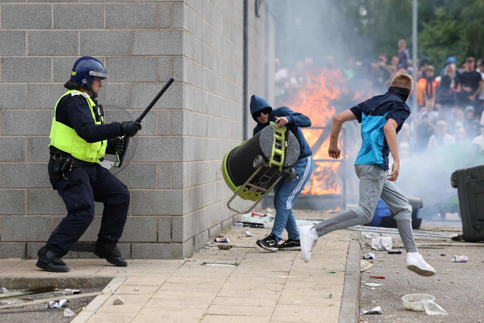 A demonstrator runs away from a police officer during an anti-immigration protest, in Rotherham, Britain. (Reuters)