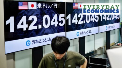 An employee of the foreign exchange trading company Gaitame.com walks past monitors displaying the Japanese yen exchange rate against the U.S. dollar in Tokyo, Japan, August 5, 2024.