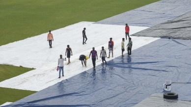 AFG vs NZ Day 1 Test 2024 Weather Updates: Groundsmen cover the Greater Noida Sports Complex ground during rains on the eve of the one-off Test cricket match between New Zealand and Afghanistan.