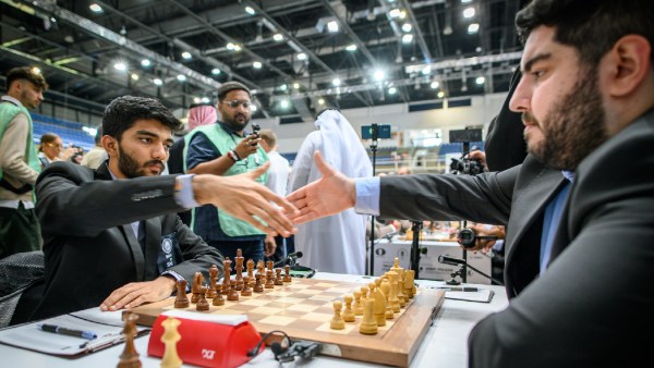 Iran’s Parham Maghsoodloo greets India's Gukesh ahead of their clash on Thursday. FIDE via Michal Walusza